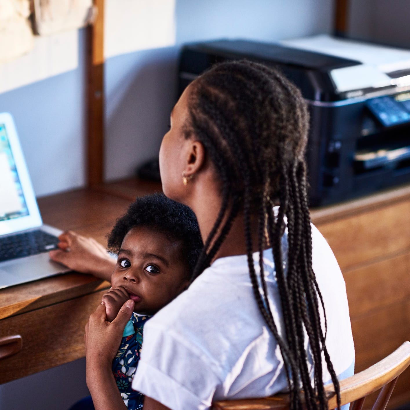 mother with baby son working on laptop