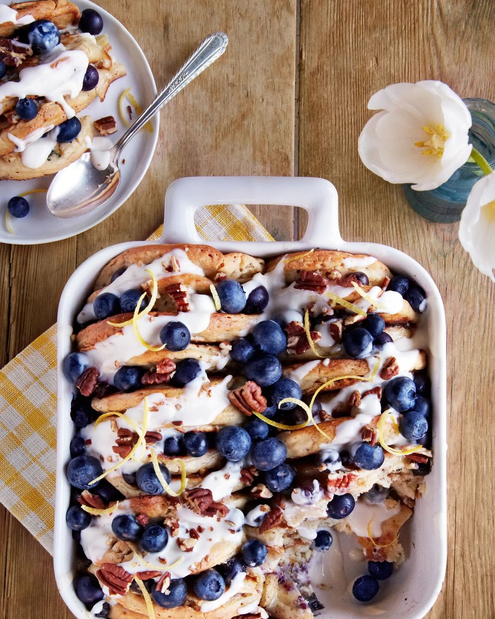 blueberry pecan pancake bread pudding covered in glazed sugar and fresh blueberries