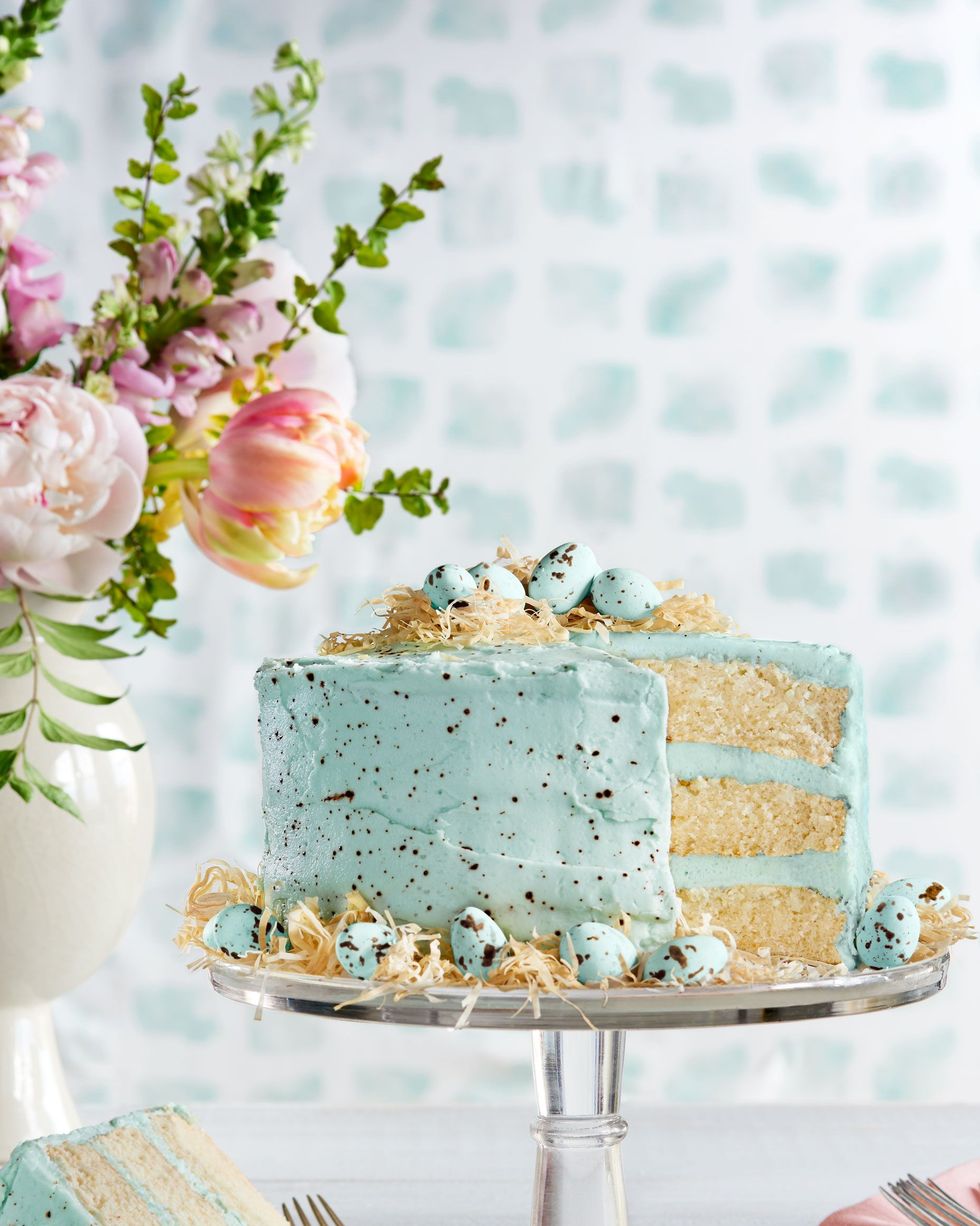 three layer malted coconut cake with light blue speckled frosting