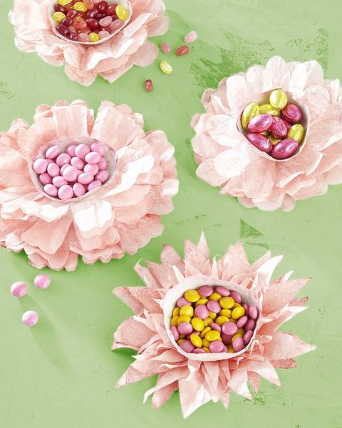 pale pink paper flowers made from dyed, cut, and stacked coffee filters with cup centers filled with pastel pink and yellow candies