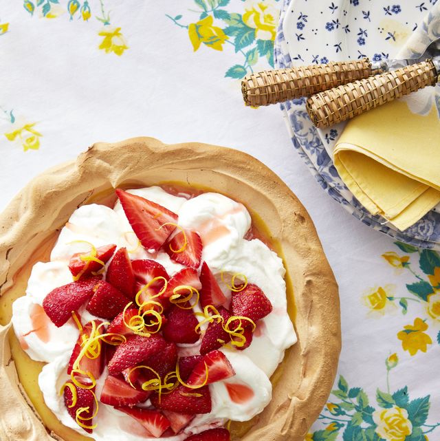 strawberry lemonade angel pie in a meringue shell and topped with whipped cream sliced strawberries and lemon zest