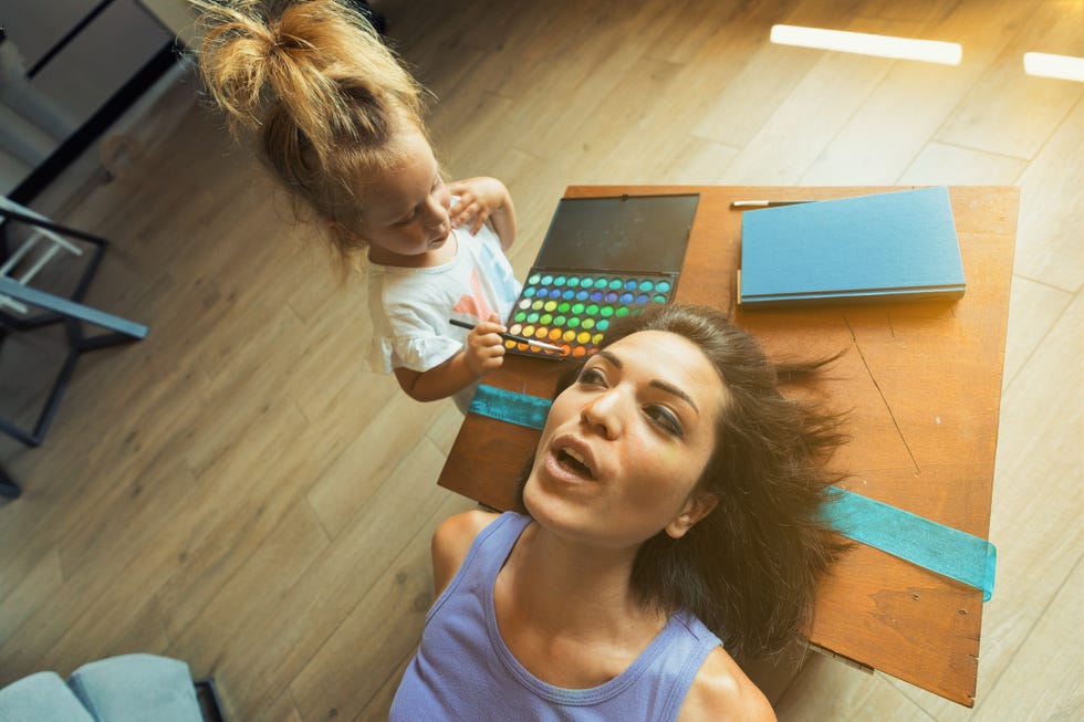 mother and daughter playing with makeup