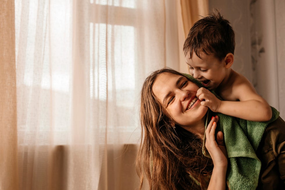 mothers day games happy mother with playful little son at home