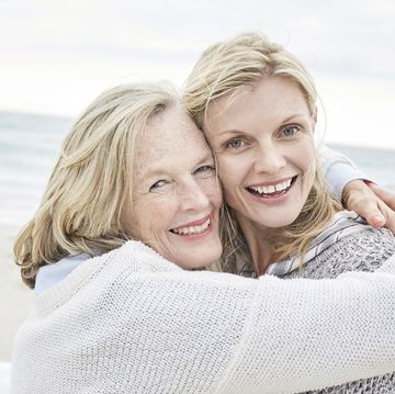 mother and daughter embracing on the beach
