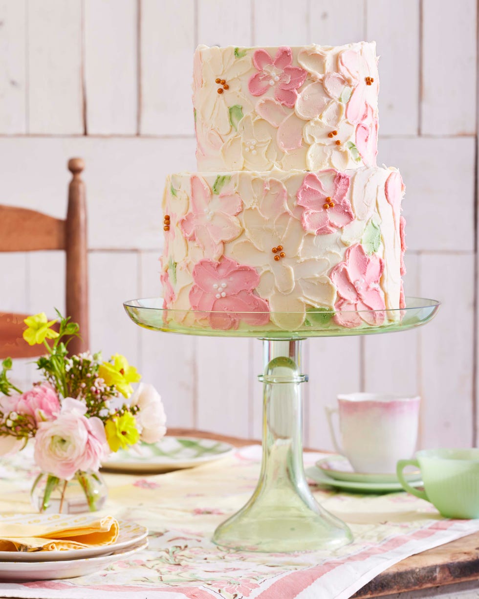 twotiered layer cake with smeared flower decorations