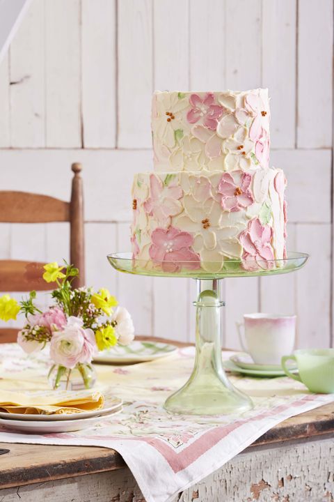 twotiered layer cake with smeared flower decorations