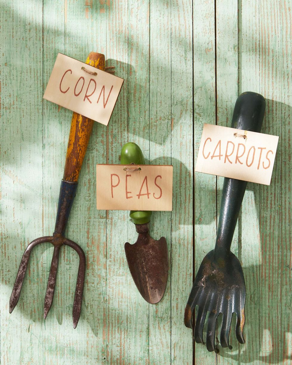 vintage garden stakes outfited with garden marker sign such as peas carrots etc