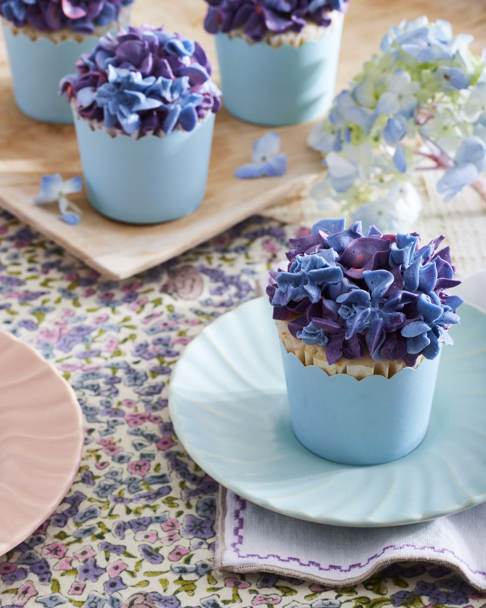 Cupcakes with purple, pink, and blue frosting piped to look like hydrangea flowers