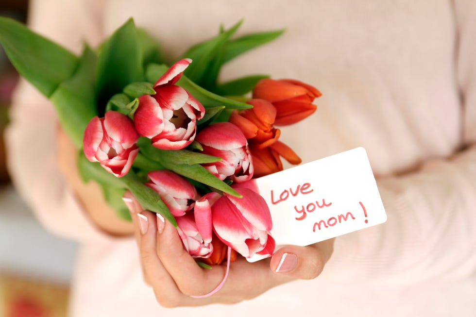 close up of hands holding tulips for mom