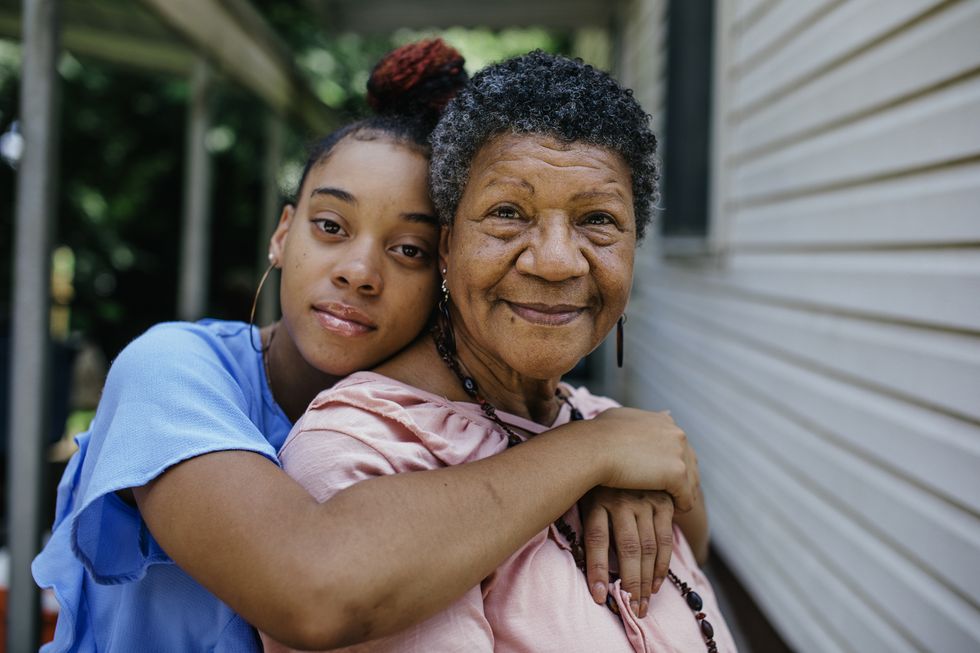 portrait of black grandmother with teenager granddaughter both are looking into the camera members of a black middle class america family