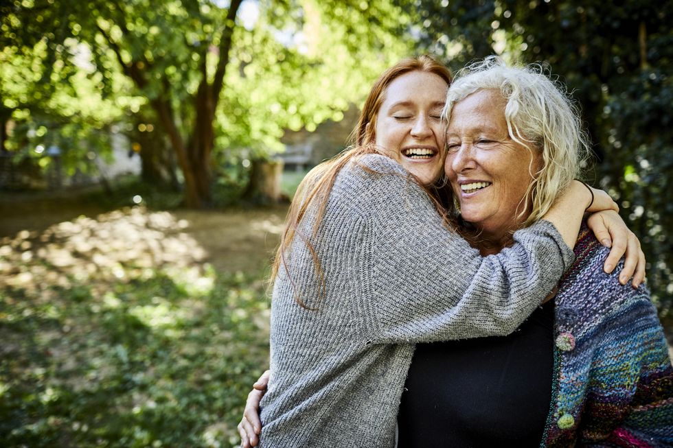 happy affectionate senior woman and young woman in garden