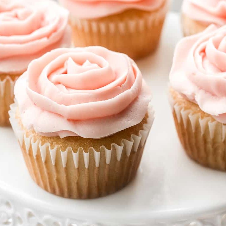 a group of cupcakes with pink frosting
