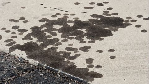 Motor oil stains on pavement surface