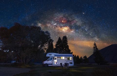 motorhome at free camp site with milky way sky in new zealand