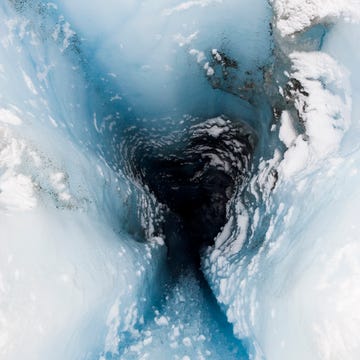 a moulin is a narrow, tubular chute or crevasse through which water enters a glacier from the surface