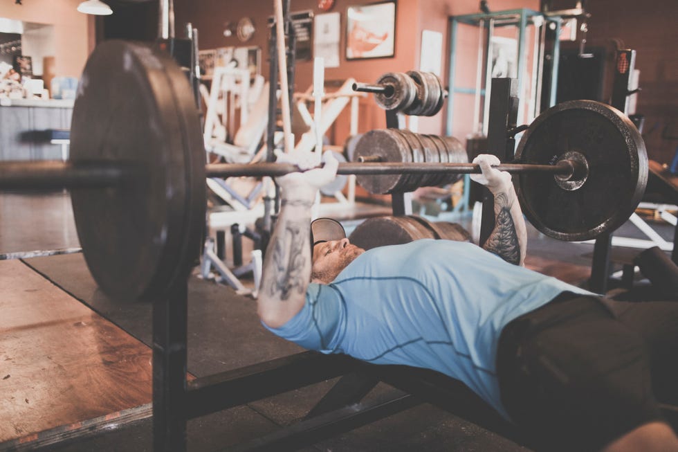 man bench pressing on a bench