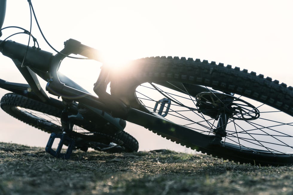 mountain bike on a mountain trail at sunrise adventure and sports in the environment