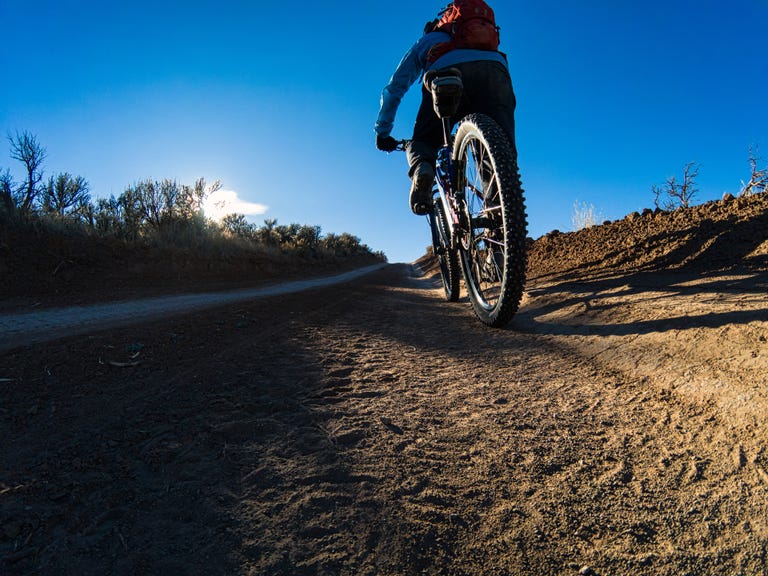 mountain biking dirt road long shadows