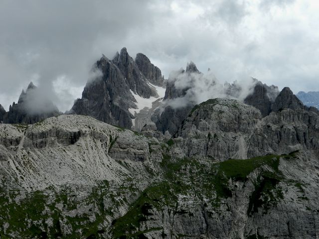 mountain peak with rock formations and clouded sky