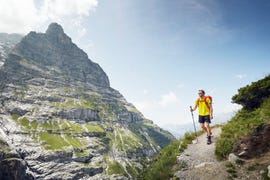 mountaineer hiking through alpine landscape