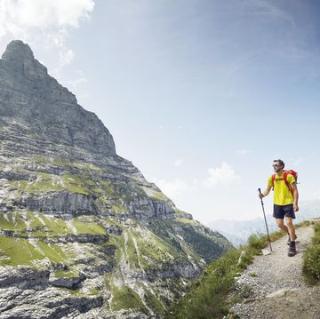 mountaineer hiking through alpine landscape