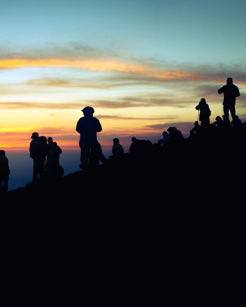 Mountaineers and Sunrise on the summit of Mount Fuji in Japan