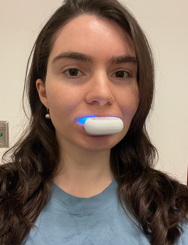 a photo of a good housekeeping institute lab scientist testing the snow teeth whitening kit