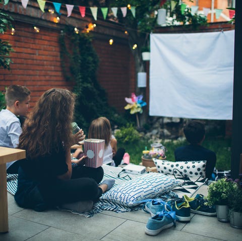 kids attend a movie night in the backyard