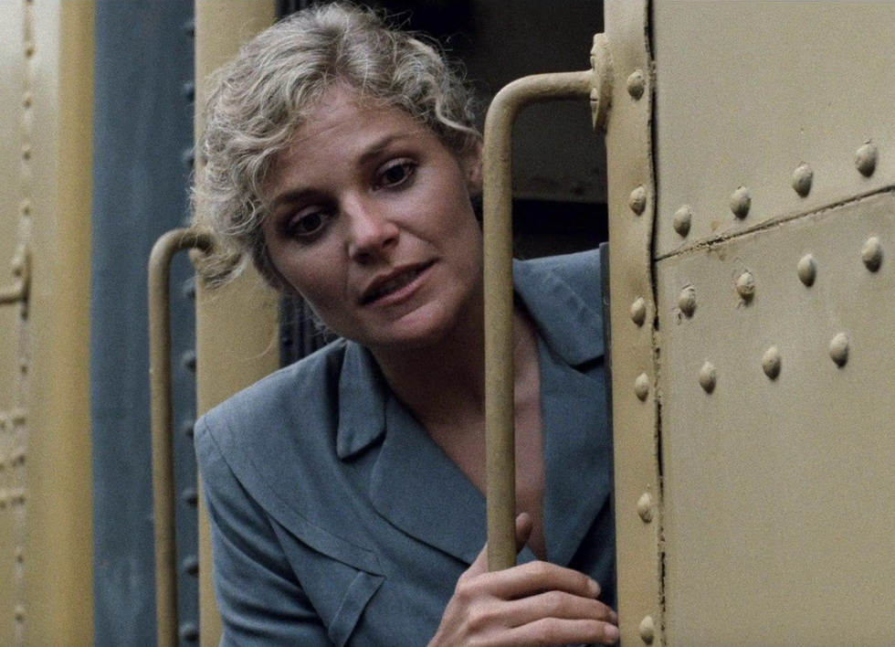 a woman on a yellow train in a still from desert hearts