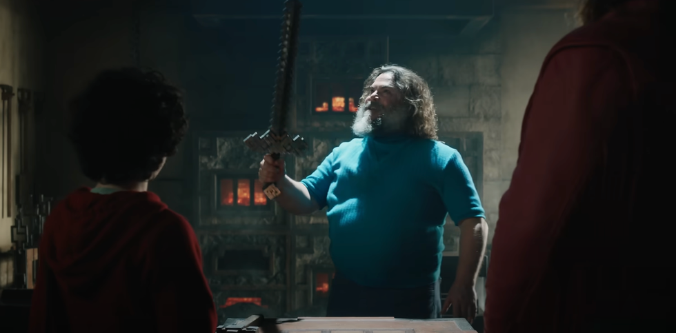 steve holds a minecraft sword in a scene from a minecraft movie, a good housekeeping pick for best kids' movies 2025