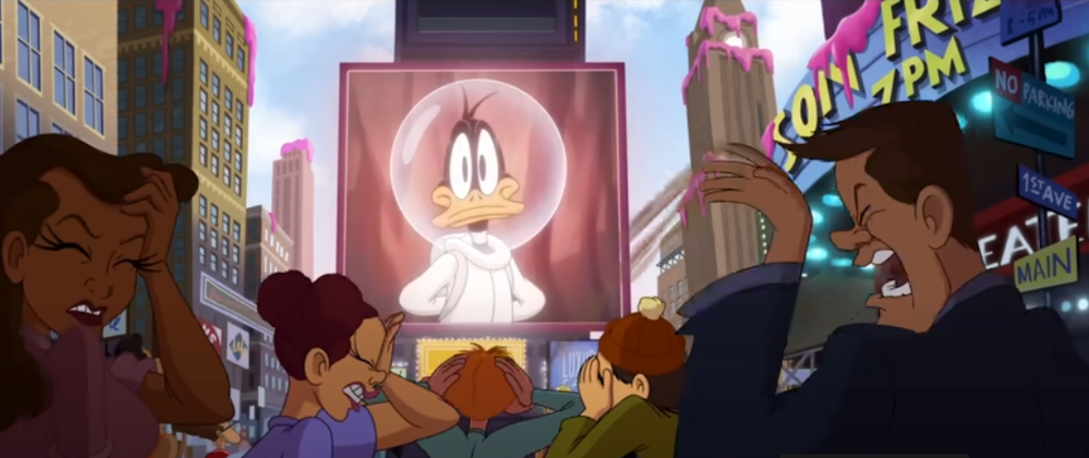 a crowd reacts negatively to a large screen showing a photo of daffy duck in a space suit in a scene from the day the earth blew up a looney tunes movie, a good housekeeping pick for best kids' movies 2025
