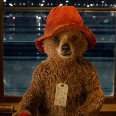 Paddington wears a tag in a scene from Paddington, a Good Housekeeping pick for best tween movies paddington wears a tag in a scene from paddington, a good housekeeping pick for best tween movies