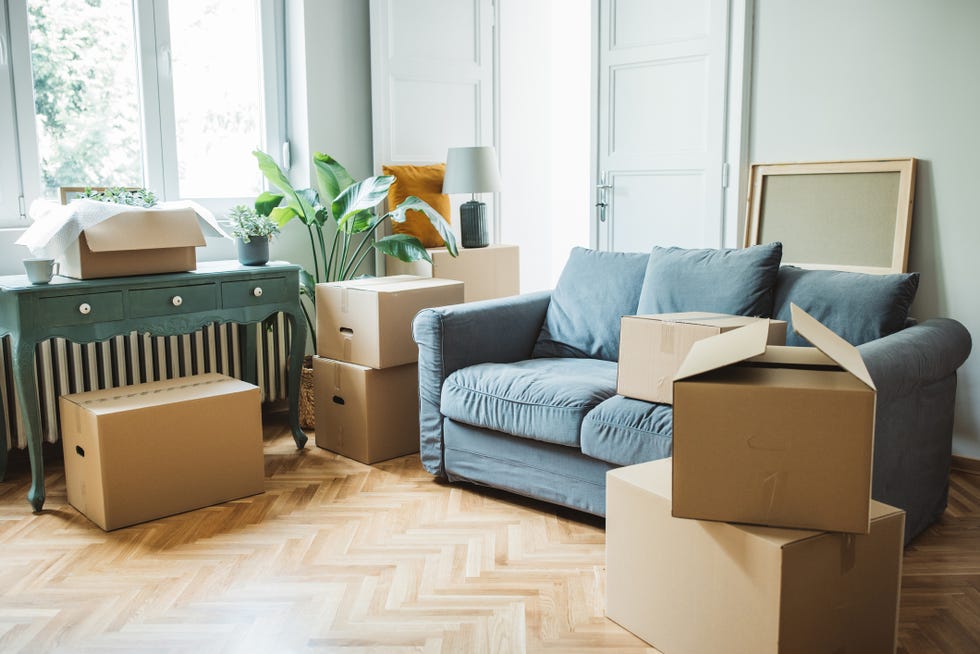 moving day concept, cardboard boxes in modern house