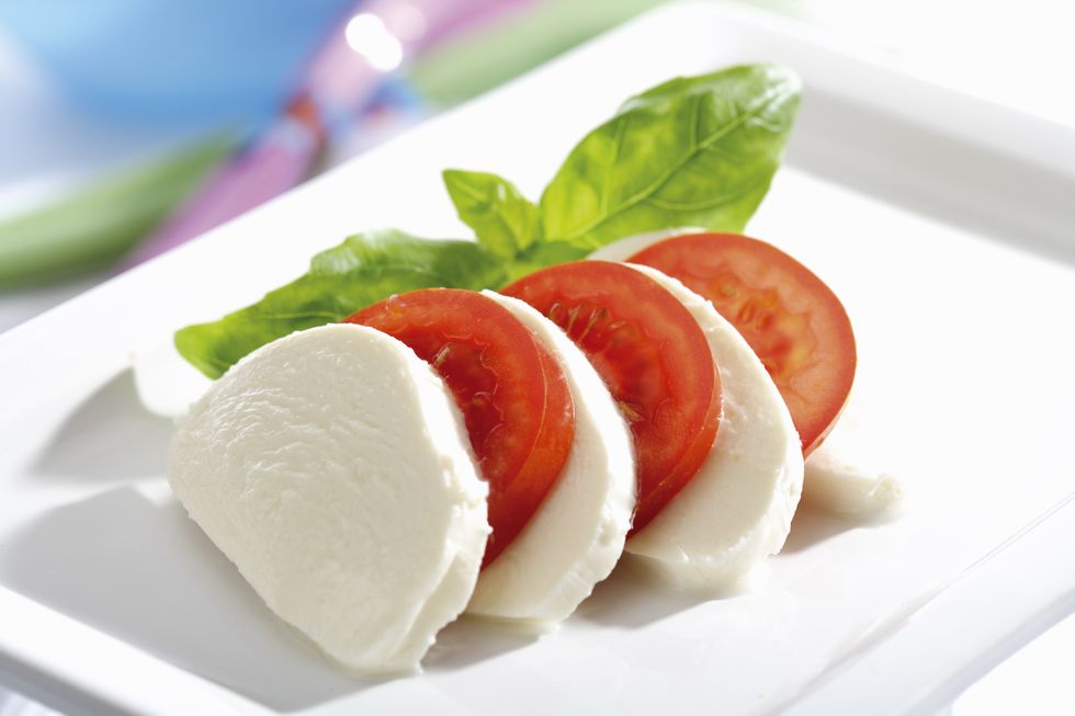 mozzarella cheese with tomatoes and basil, close up