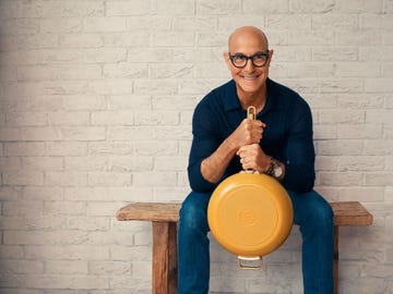 stanley tucci holding a yellow pan