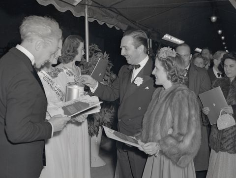 walt disney and wife arriving at movie premiere