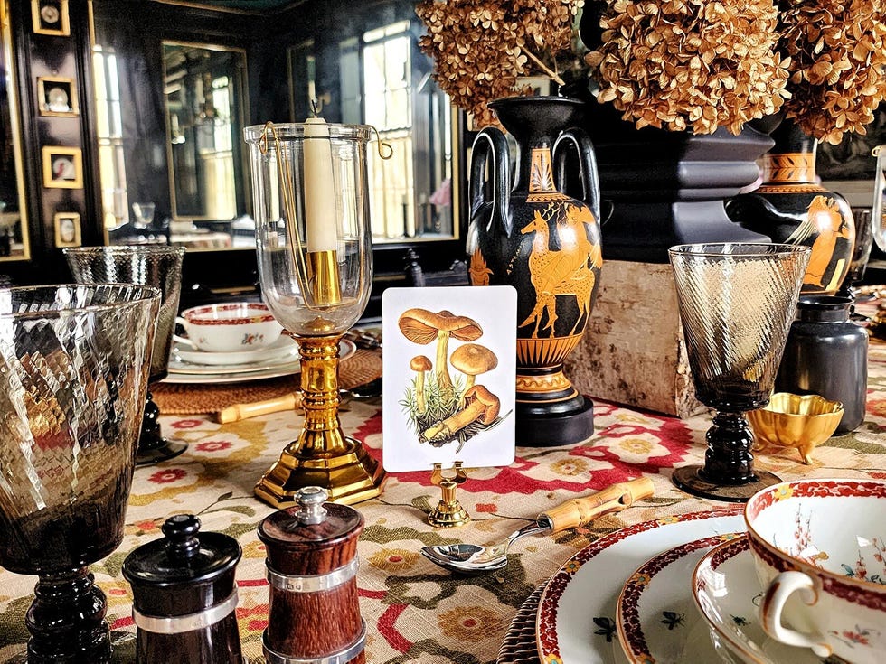 lavish table display lavish table display with greek vases, a mushroom themed place card, an ornate suzani tablecloth, and other elements