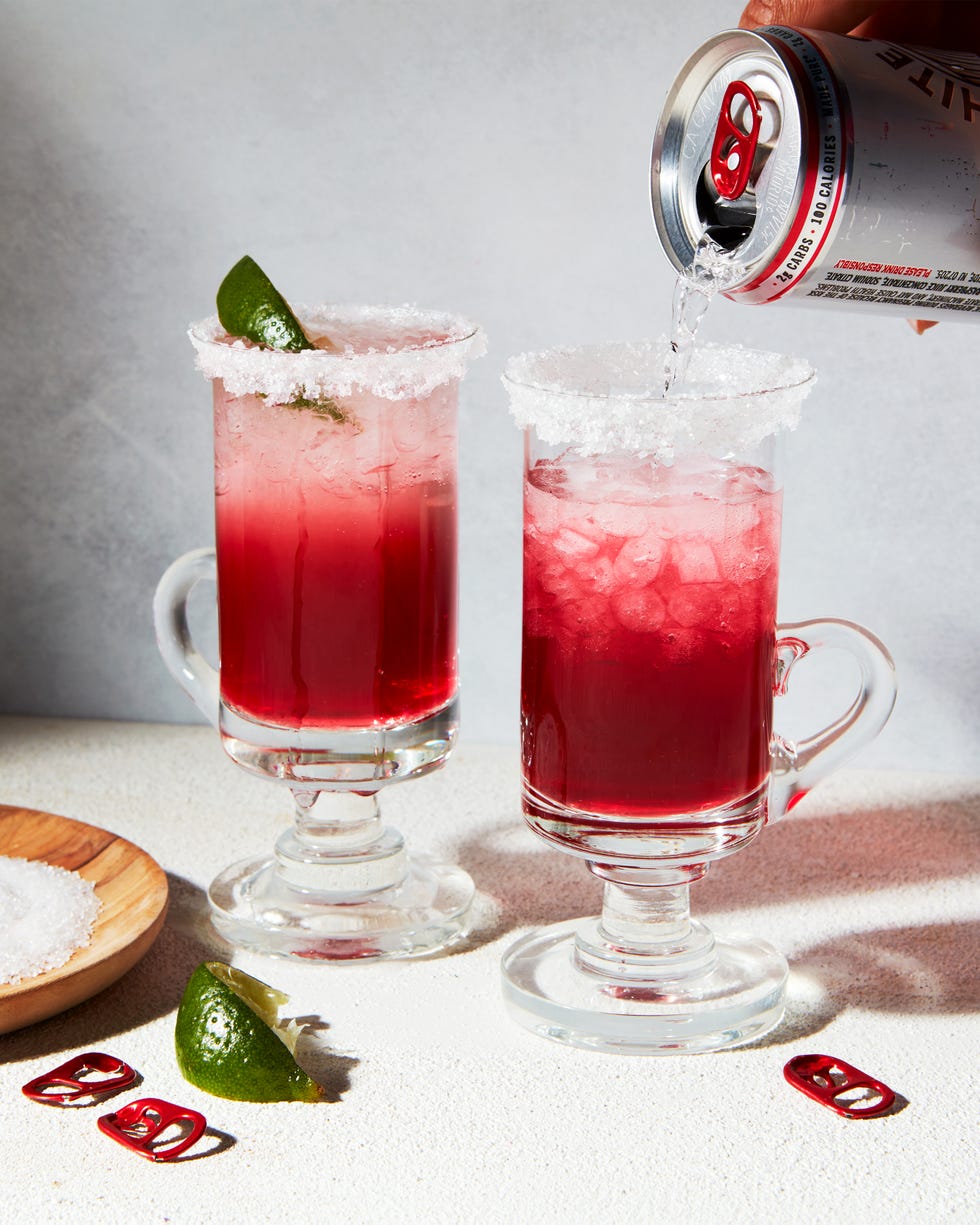 cocktail with raspberry white claw, lime, and a sugar rim