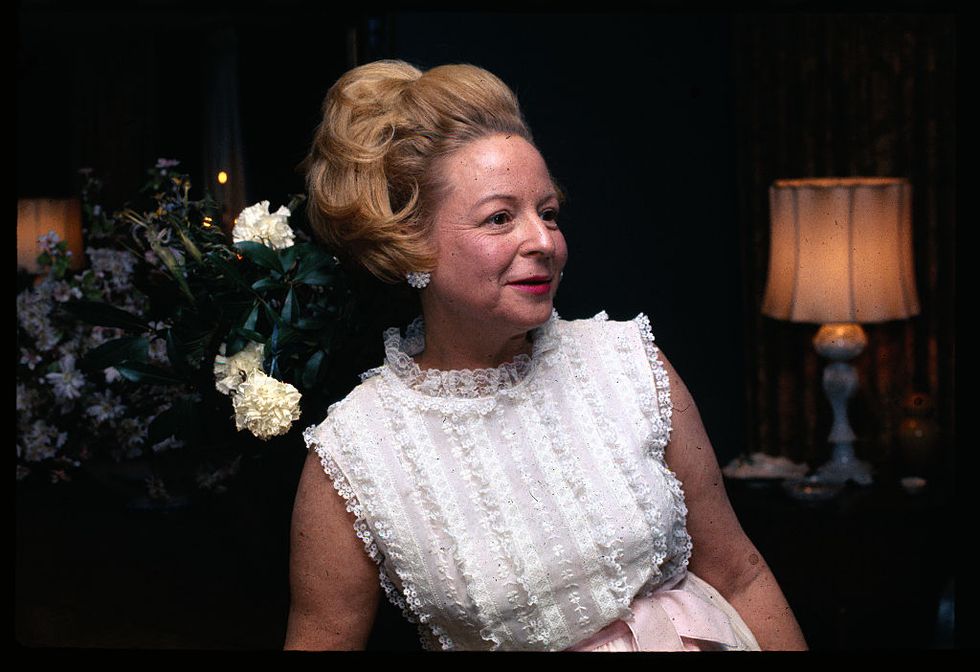 martha mitchell seated at a piano