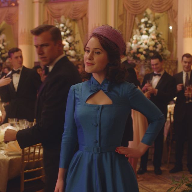 midge maisel at the plaza in a blue dress and pink hat