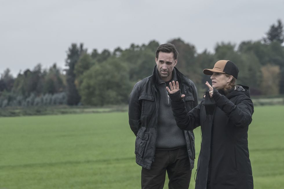 the mother l to r joseph fiennes as adrian, niki caro director on the set of the mother cr doane gregorynetflix © 2023