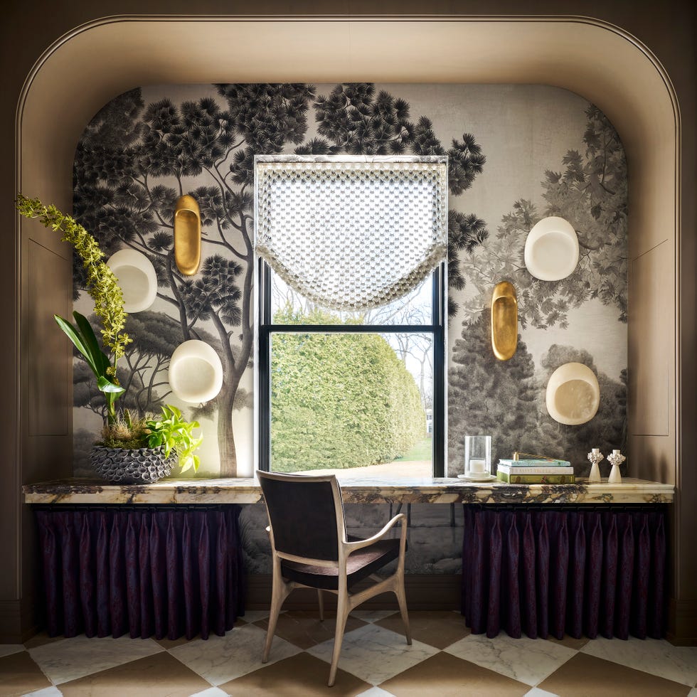 desk in front of window and mural wallpaper of trees