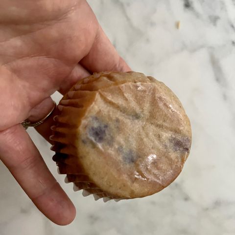 holding muffin with greasy bottom facing up