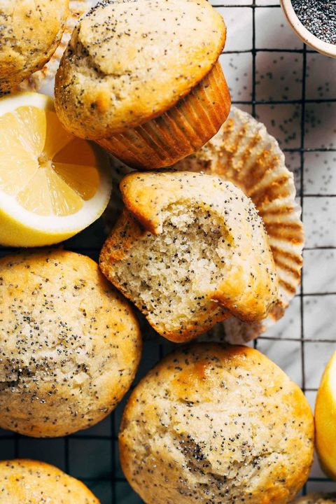 lemon poppy seed muffins with lemons on wire rack