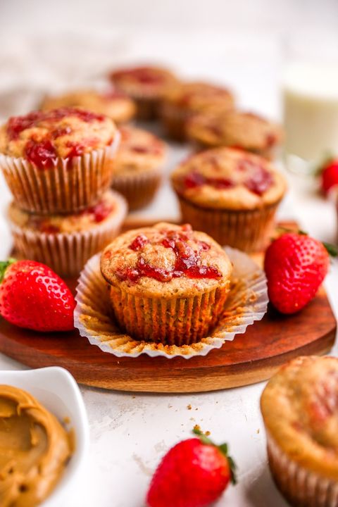 peanut butter and jelly muffins with fresh stawberries on wood board