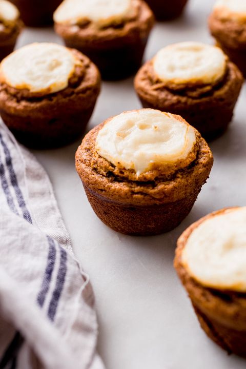 spiced chai pumpkin cheesecake muffins with kitchen towel