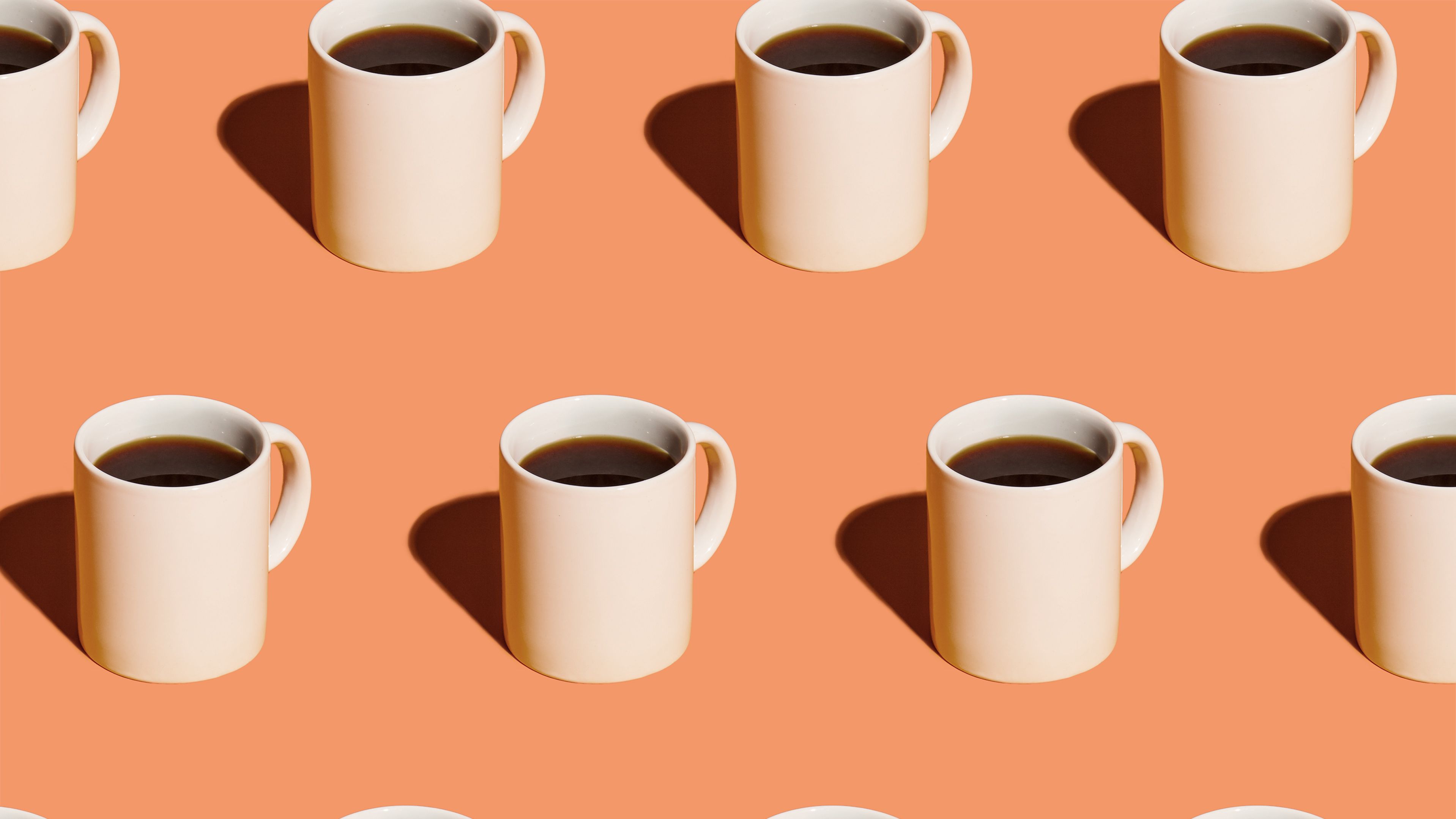 https://hips.hearstapps.com/hmg-prod/images/mugs-of-black-coffee-in-rows-against-peach-royalty-free-image-1584741659.jpg?crop=1xw:0.43155xh;center,top
