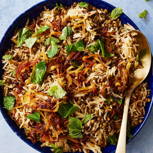 long grain rice and lentils with crispy onions topped with fresh mint in a bowl