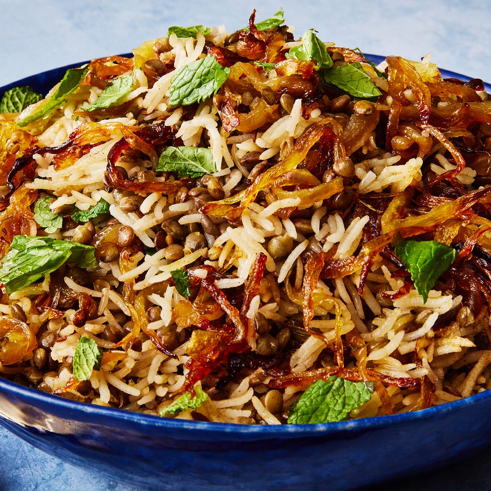 long grain rice and lentils with crispy onions topped with fresh mint in a bowl