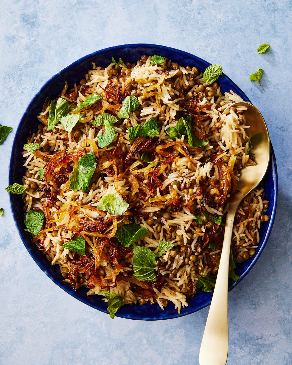 long grain rice and lentils with crispy onions topped with fresh mint in a bowl